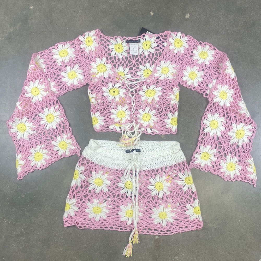 Pink crocheted top and bottom set with daisy patterns